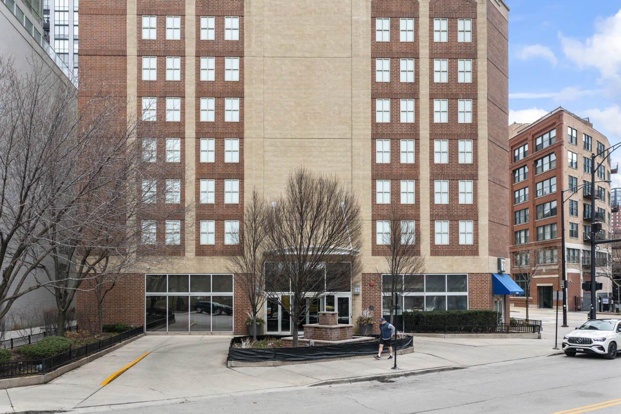 a building with a street sign on a sidewalk