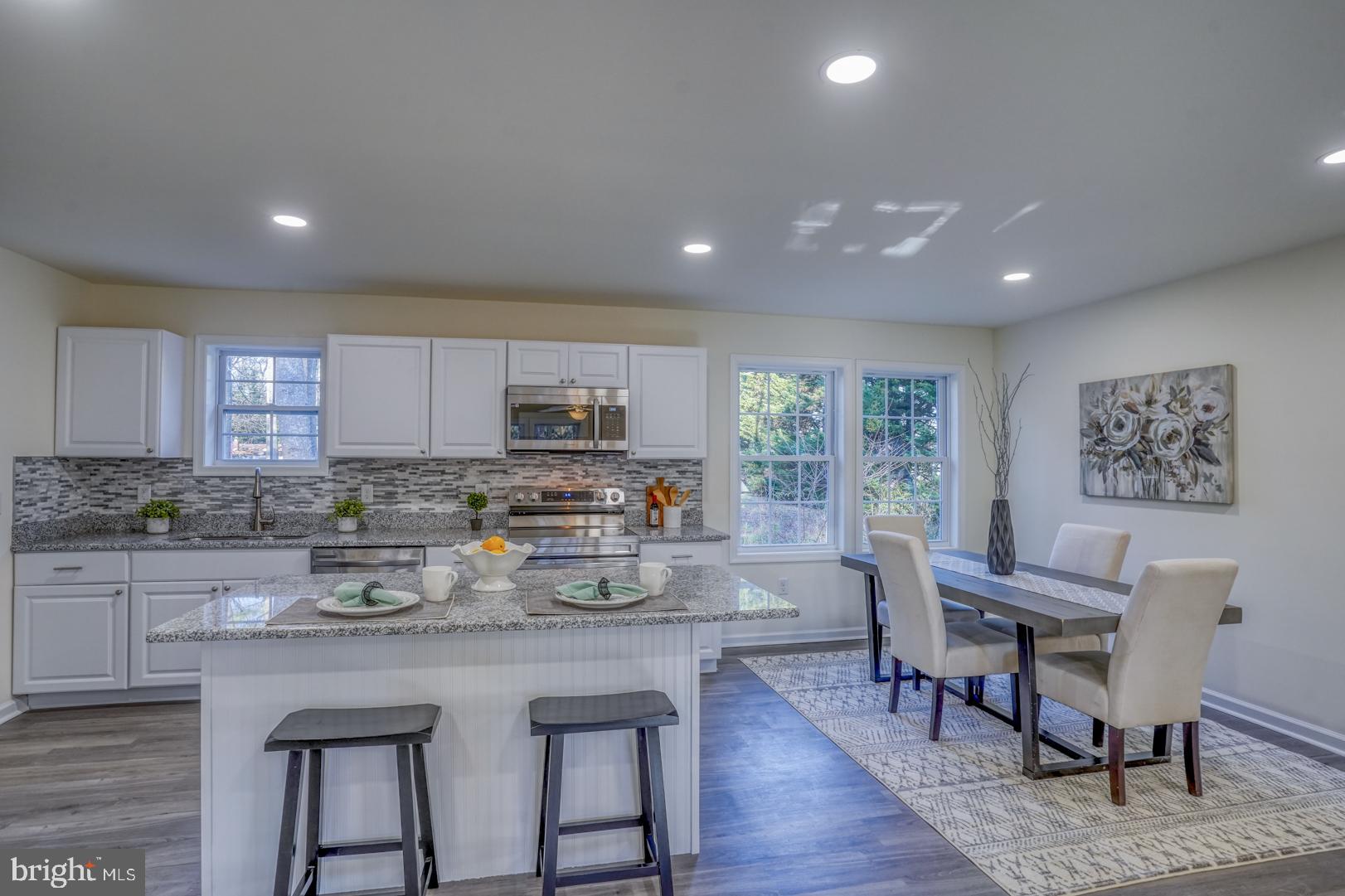 a kitchen with counter space furniture and wooden floor