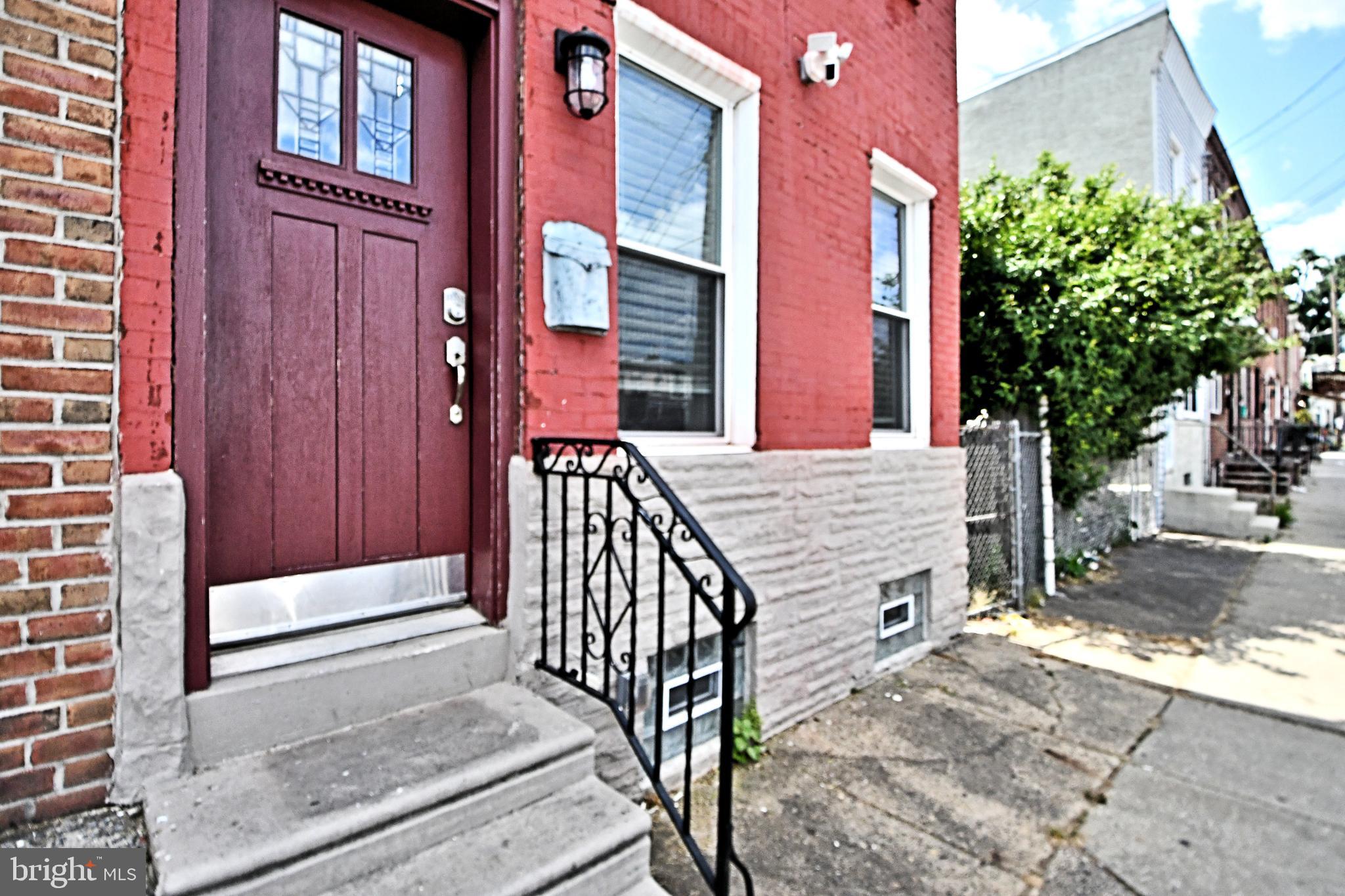 a view of a house with a bench and floor to ceiling windows