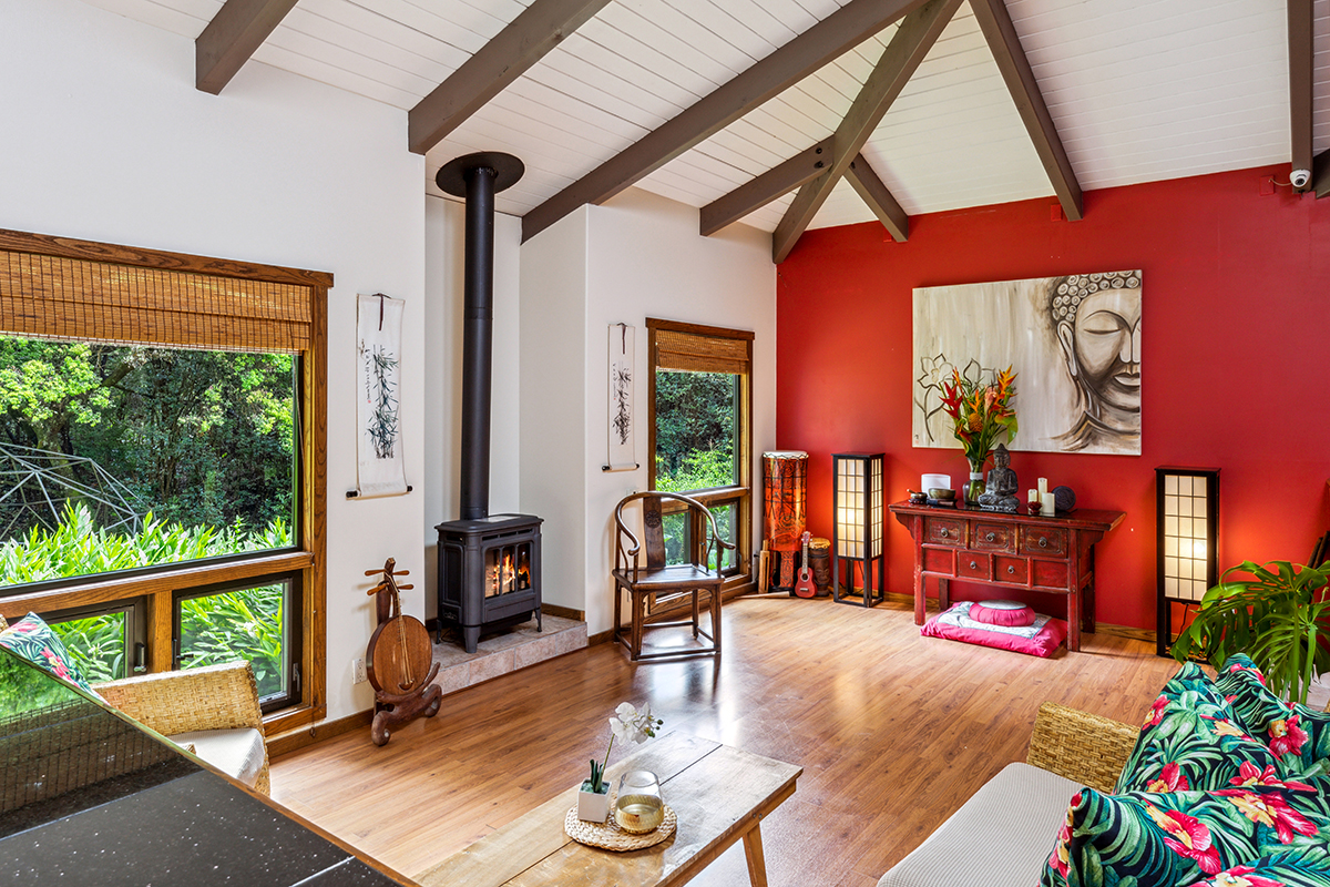 a living room with furniture a fireplace and large windows