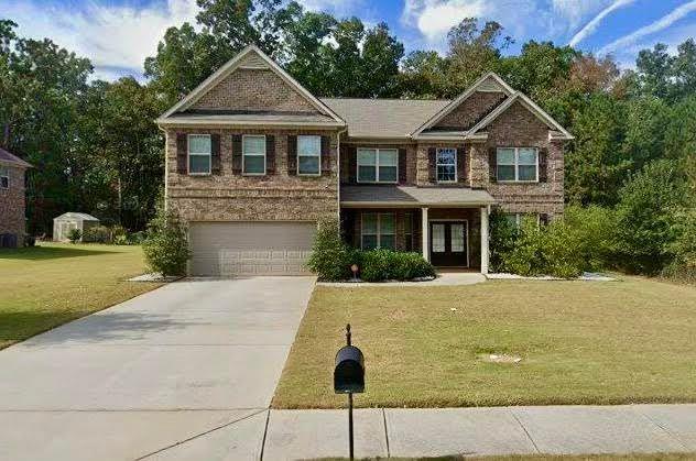 a front view of a house with yard