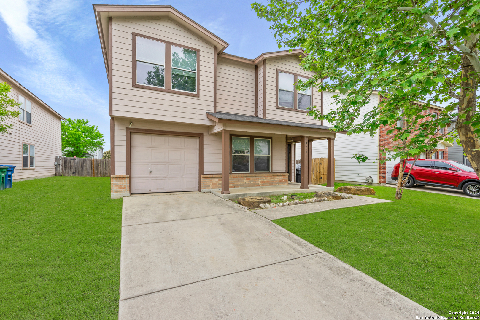 a front view of a house with that has a yard