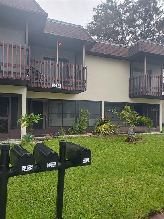 a front view of house with yard and outdoor seating