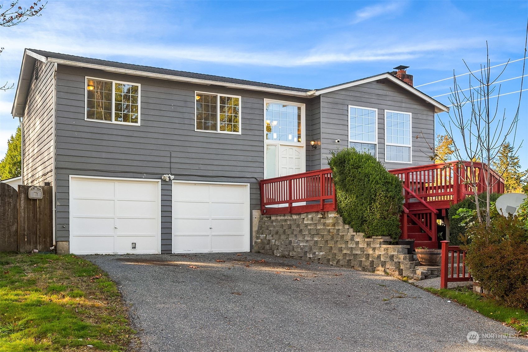 a view of a house with a yard and garage