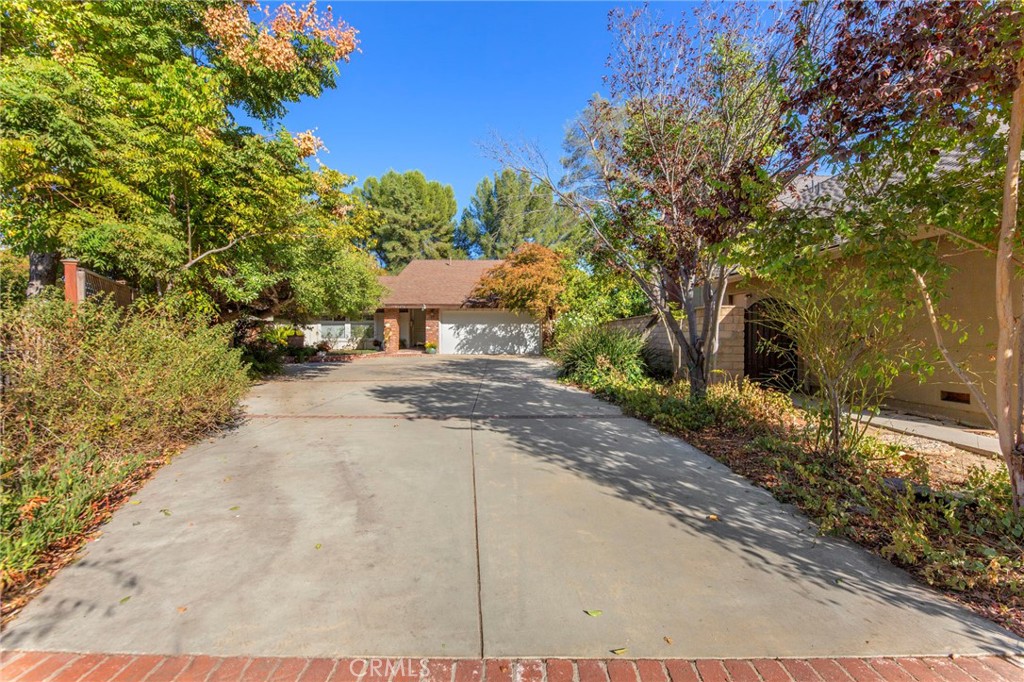 a pathway of a house with a yard