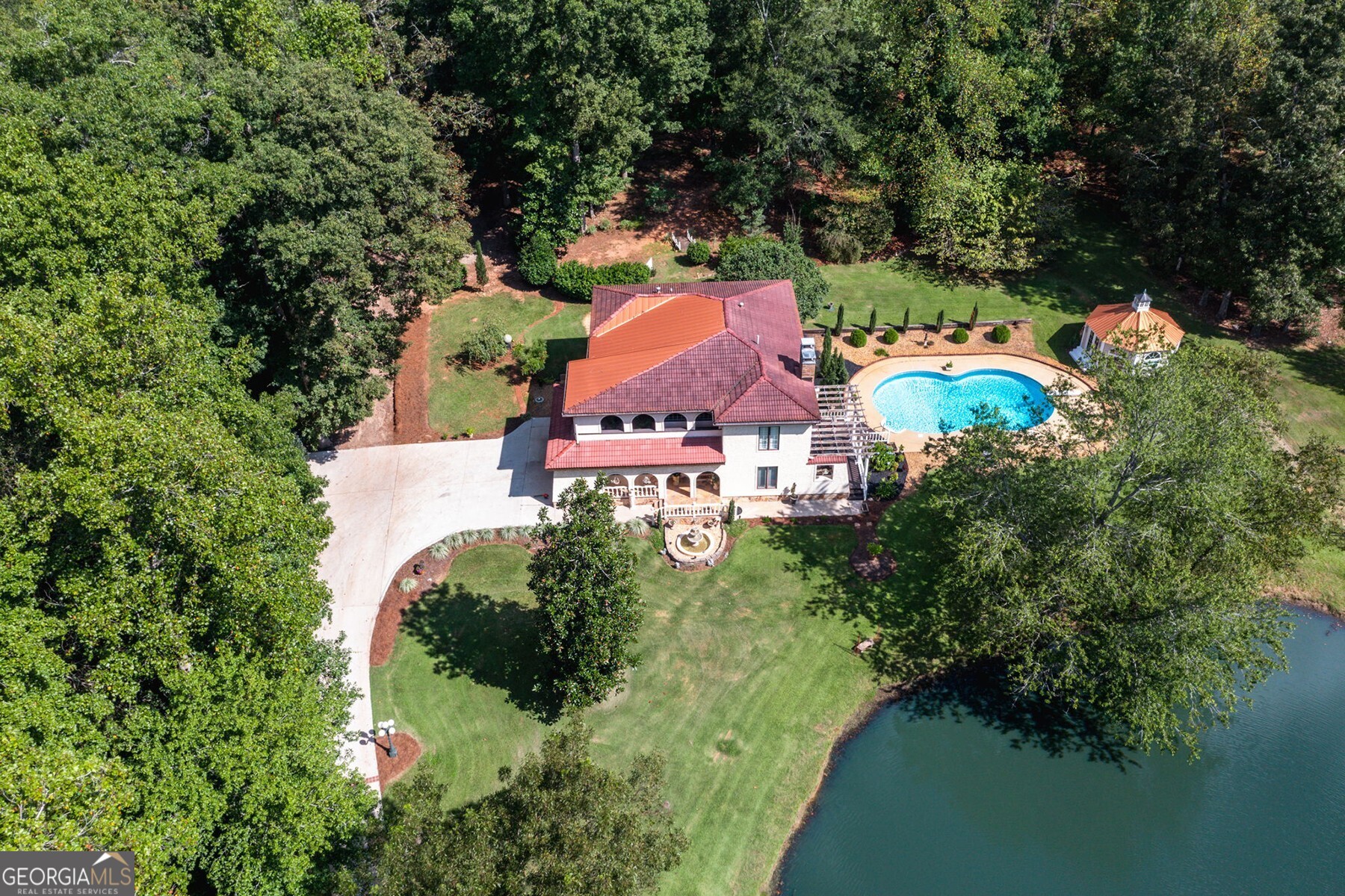 an aerial view of a house with garden space and street view