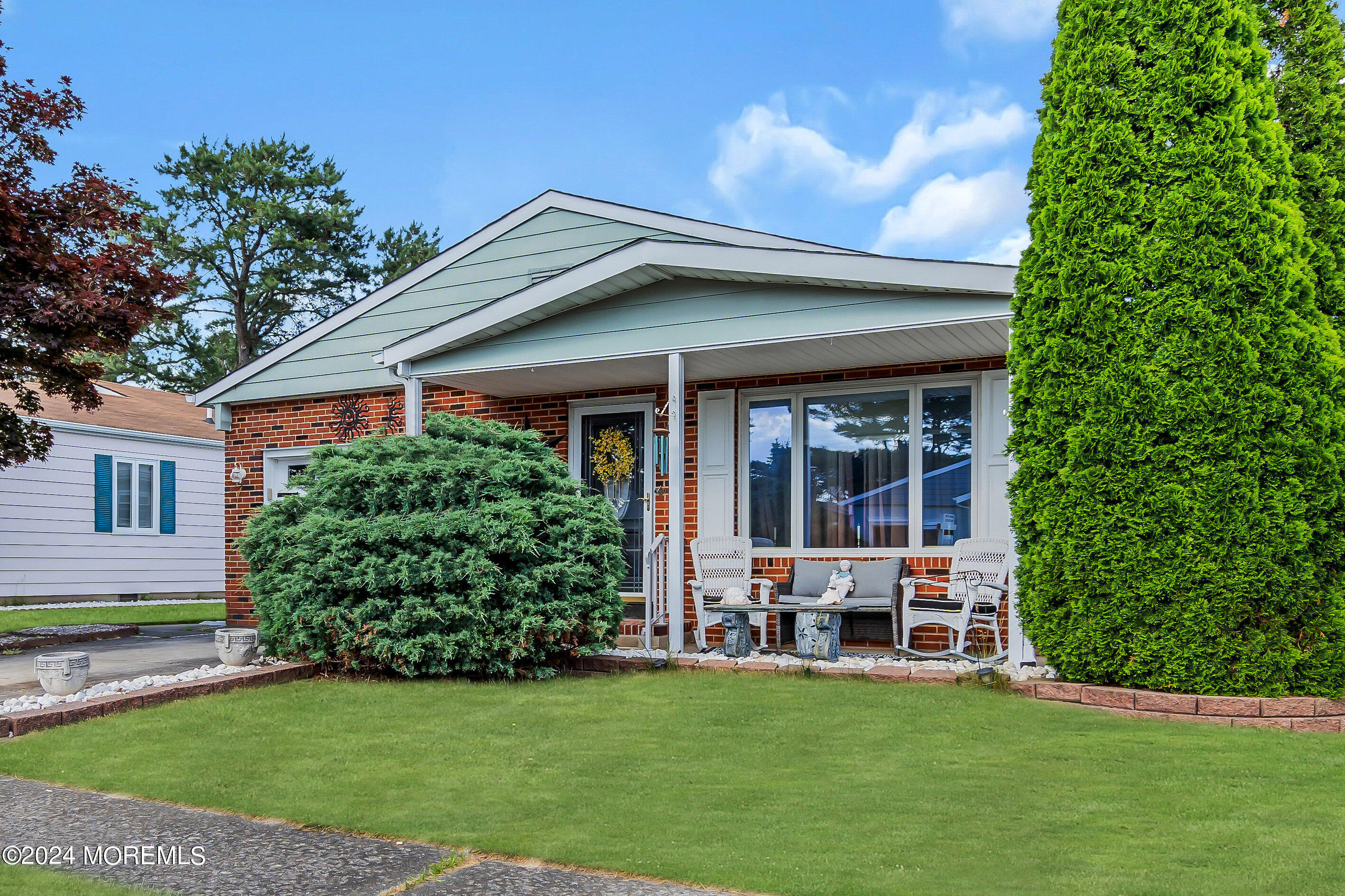 a view of a house with a yard and sitting area