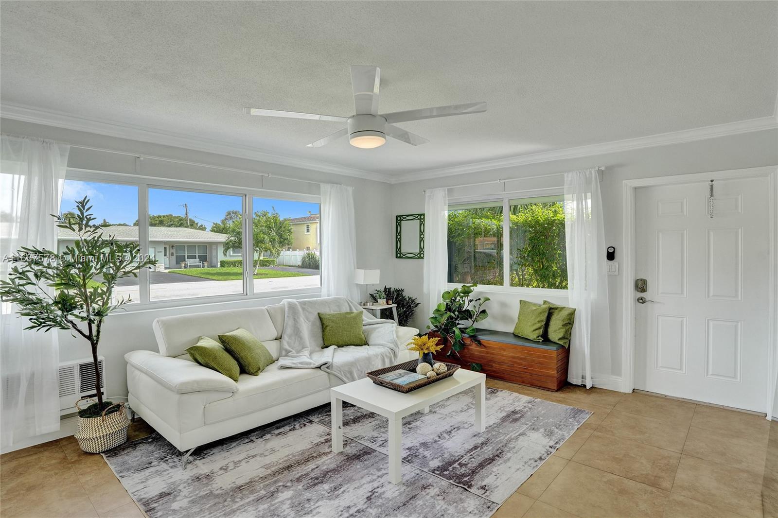 a living room with furniture and a potted plant