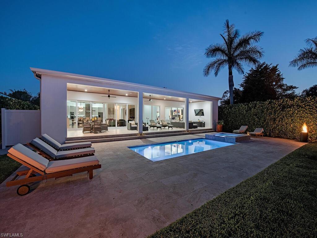 a view of a house with swimming pool and sitting area