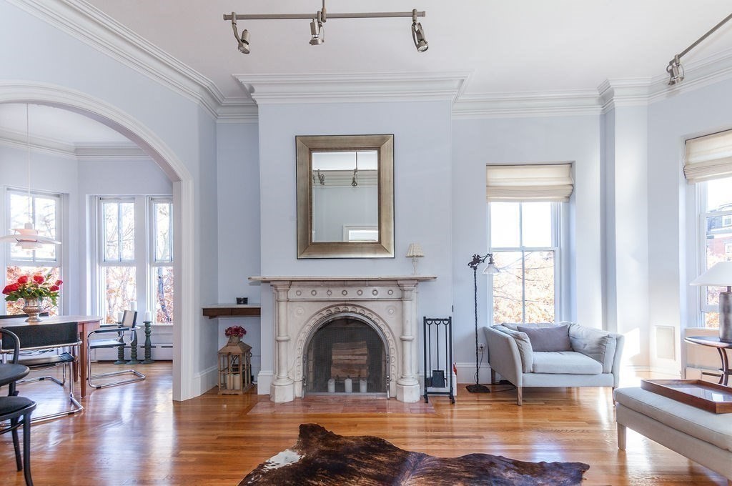 a living room with furniture window and wooden floor