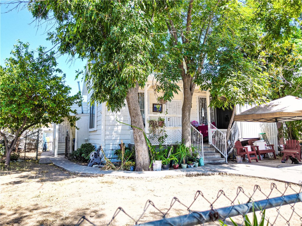 a front view of a house with a tree