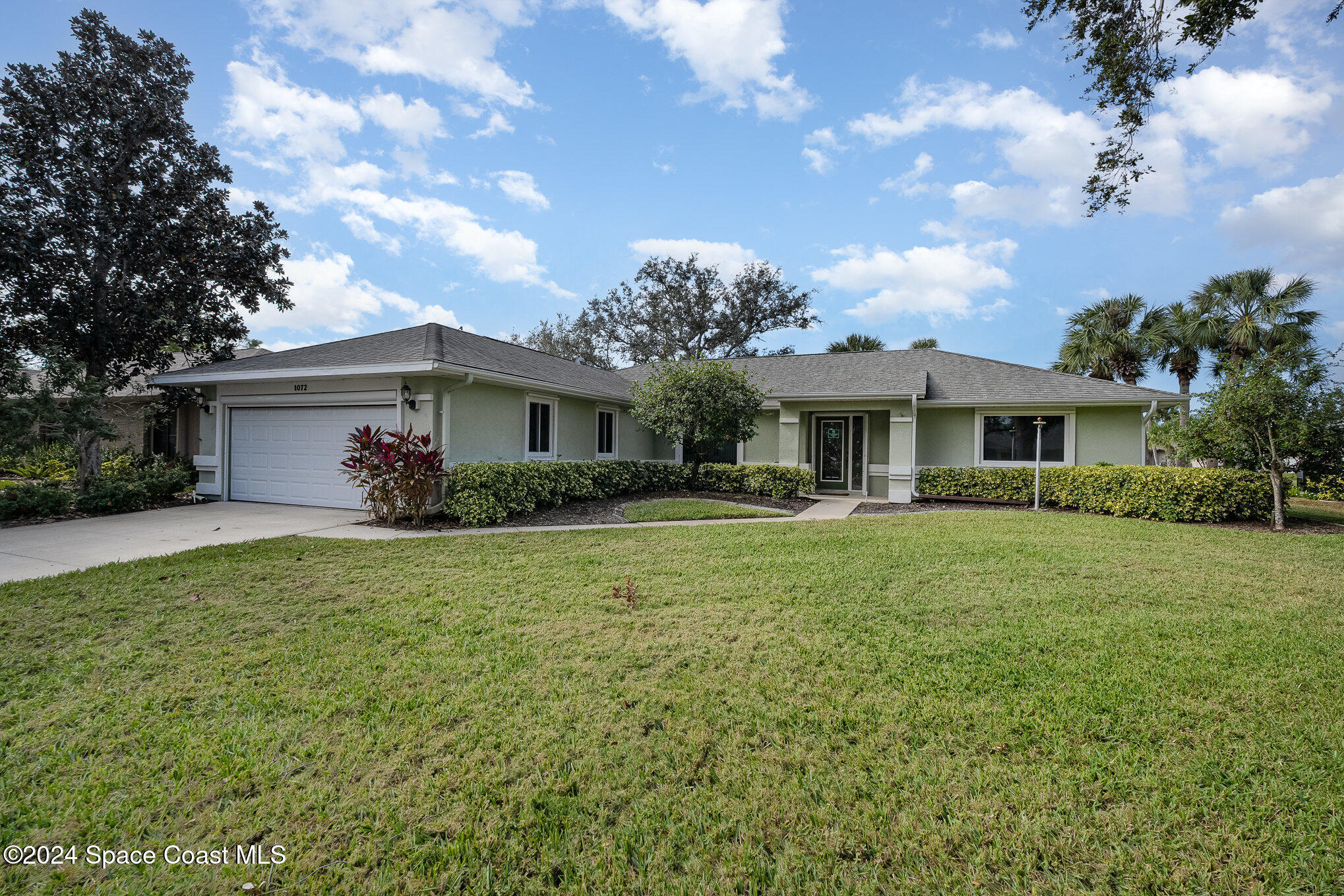 a front view of house with yard and green space