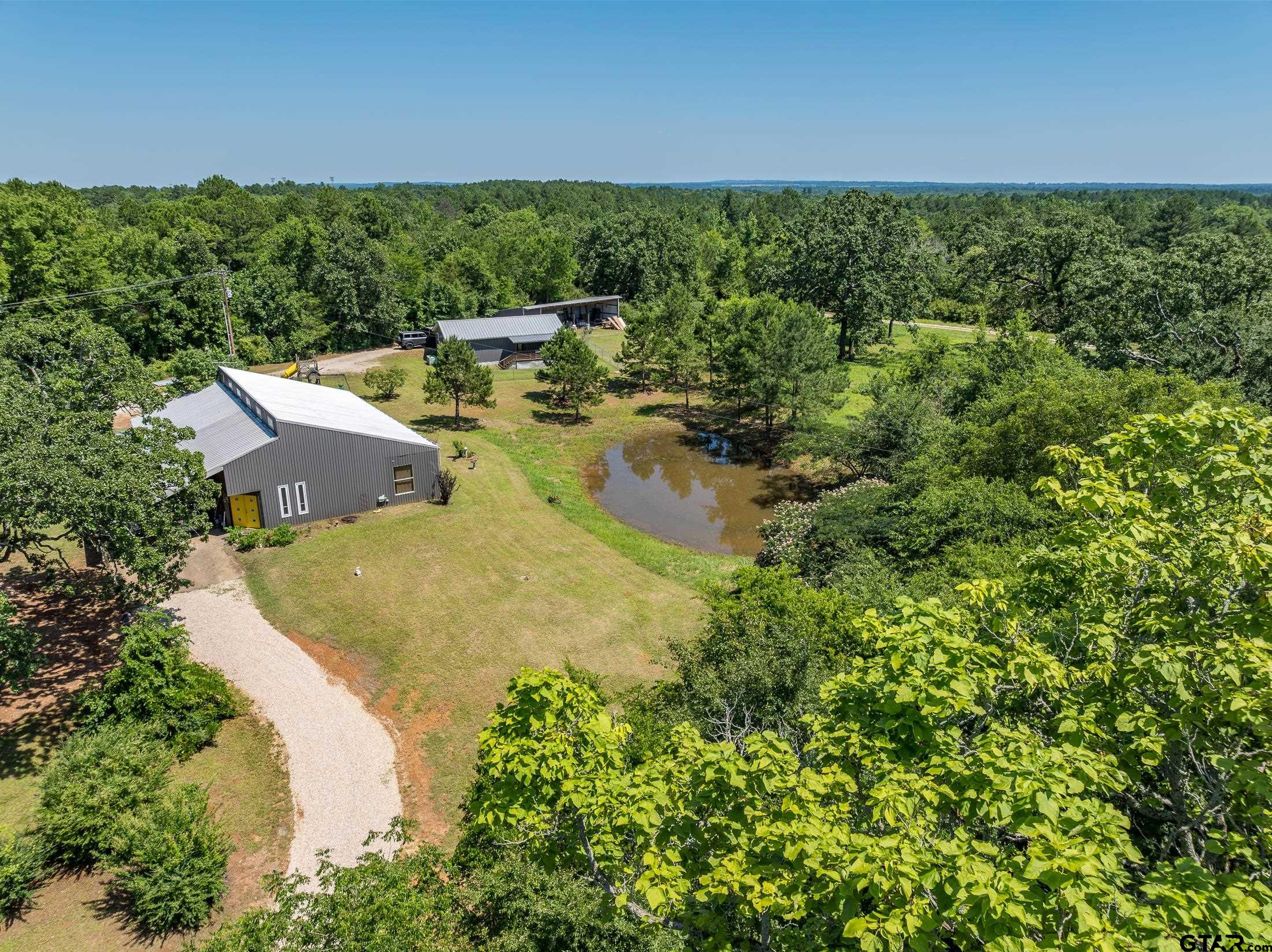 an aerial view of a house with yard and outdoor seating