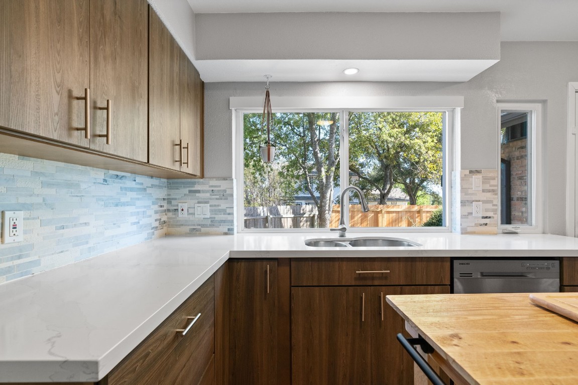 a kitchen with granite countertop a sink and a window