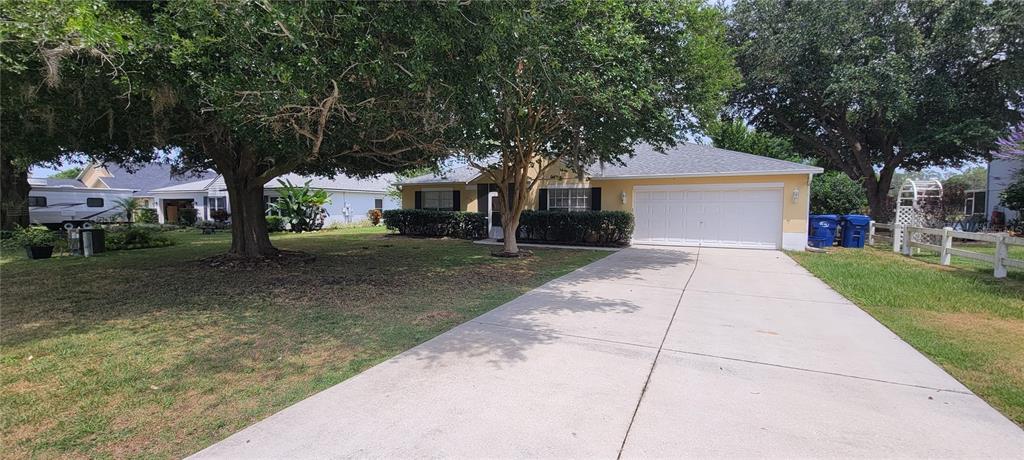 front view of a house with a yard and trees