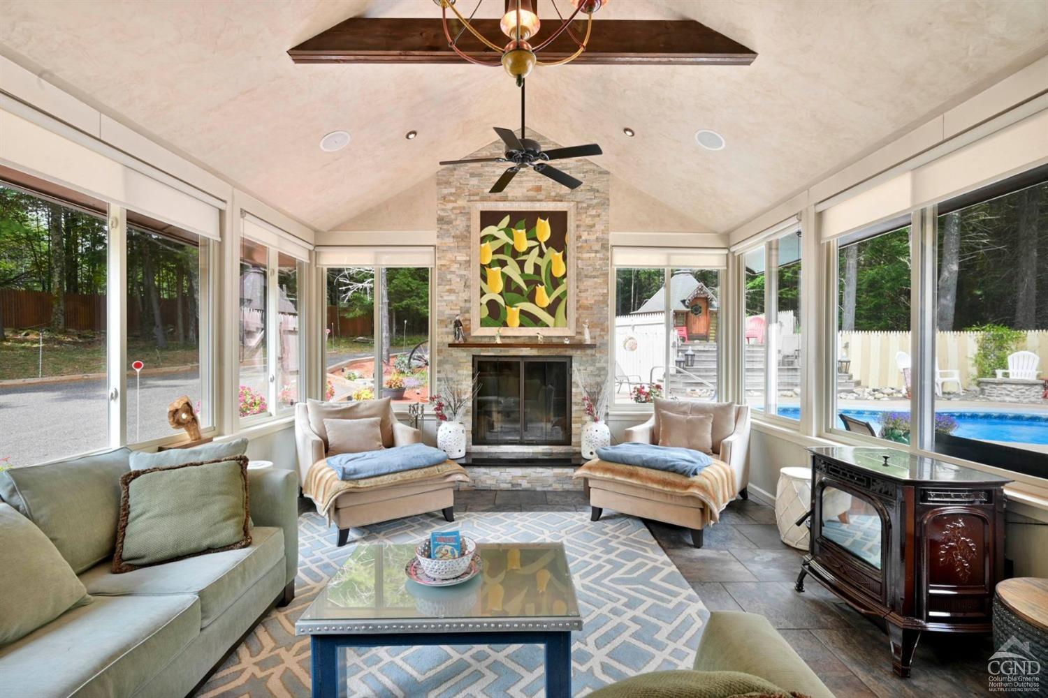 a living room with furniture a fireplace and a chandelier