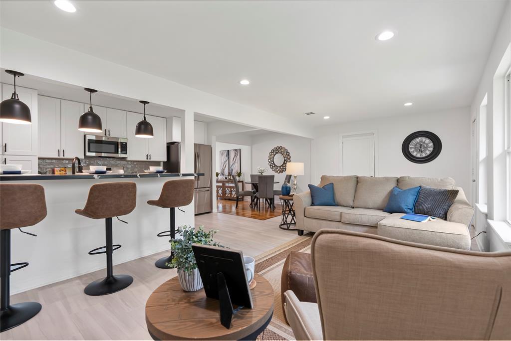 a living room with furniture and a kitchen