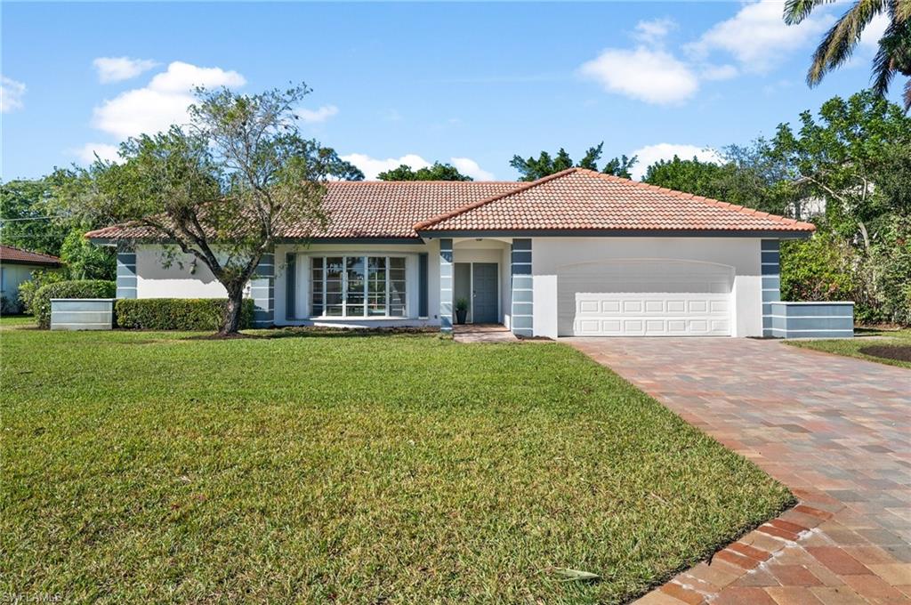 Front of home with mature trees