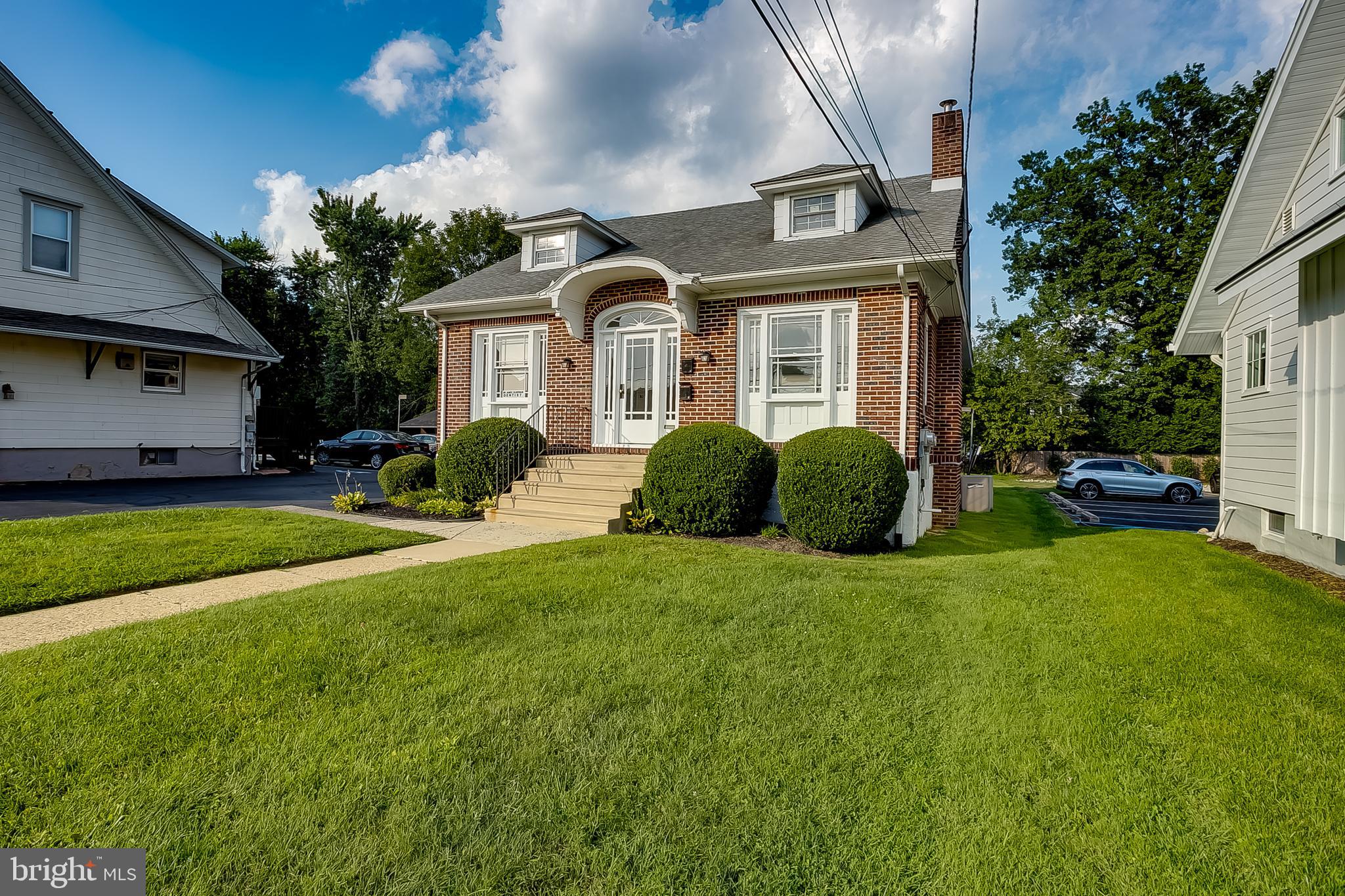 a front view of a house with a garden