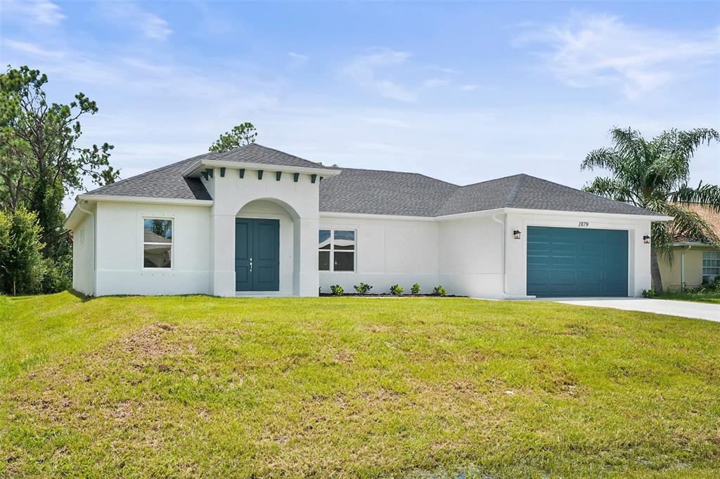 a front view of a house with a yard and garage