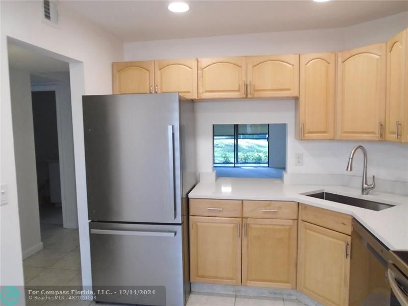 a white refrigerator freezer sitting in a kitchen