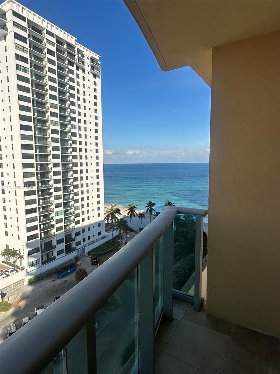 a view of balcony and floor to ceiling windows