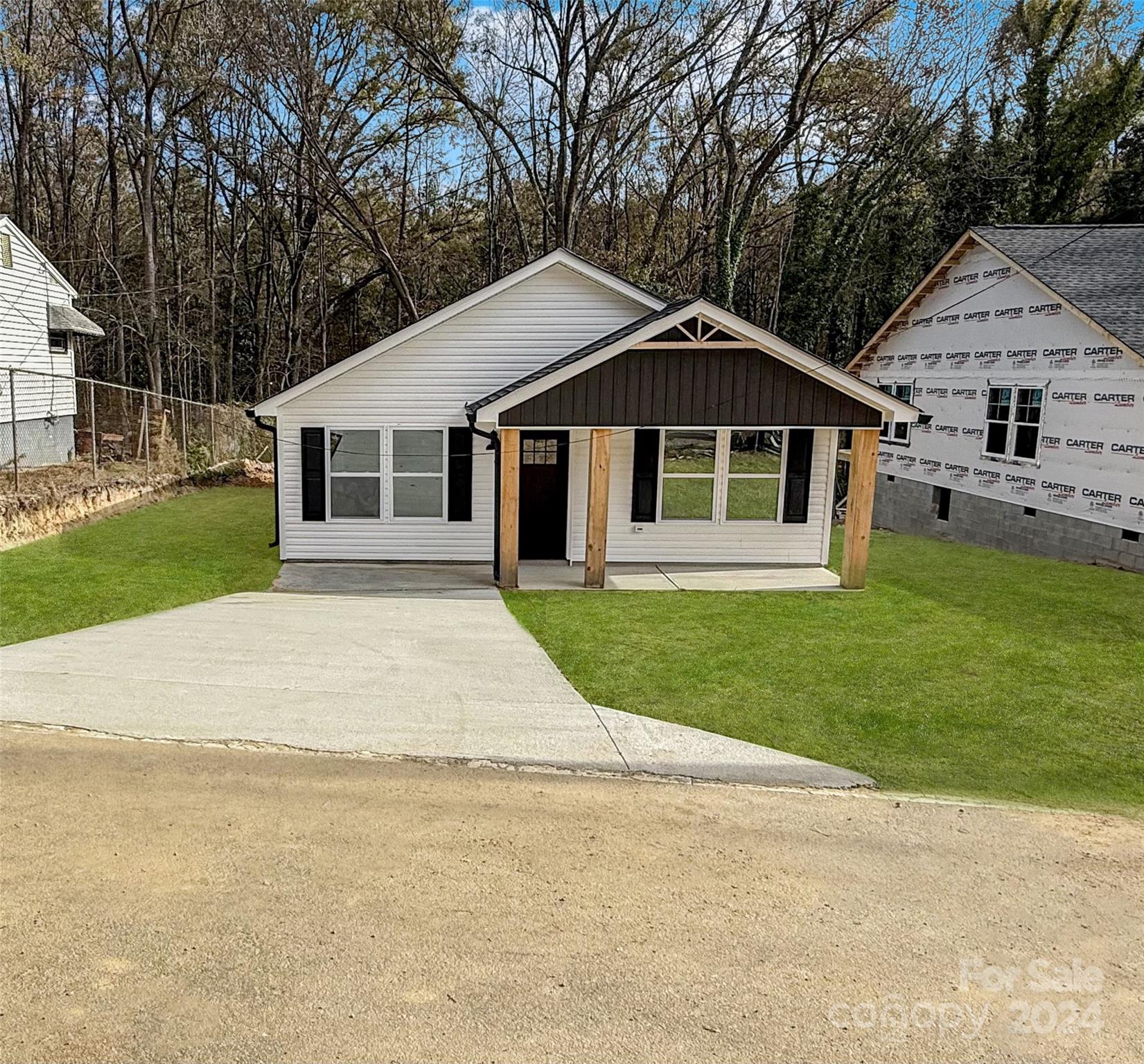 a front view of house with yard and green space