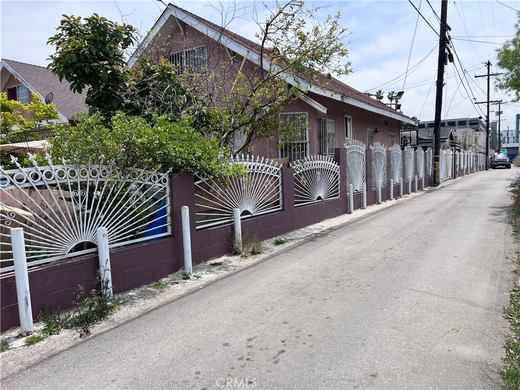 a front view of a house with garage and plants