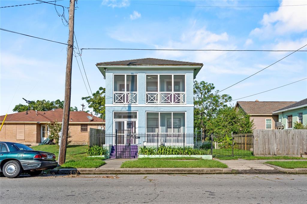 a front view of a house with a yard and potted plants