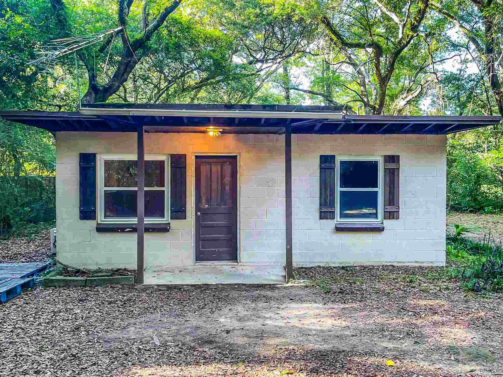 a view of a house with a backyard