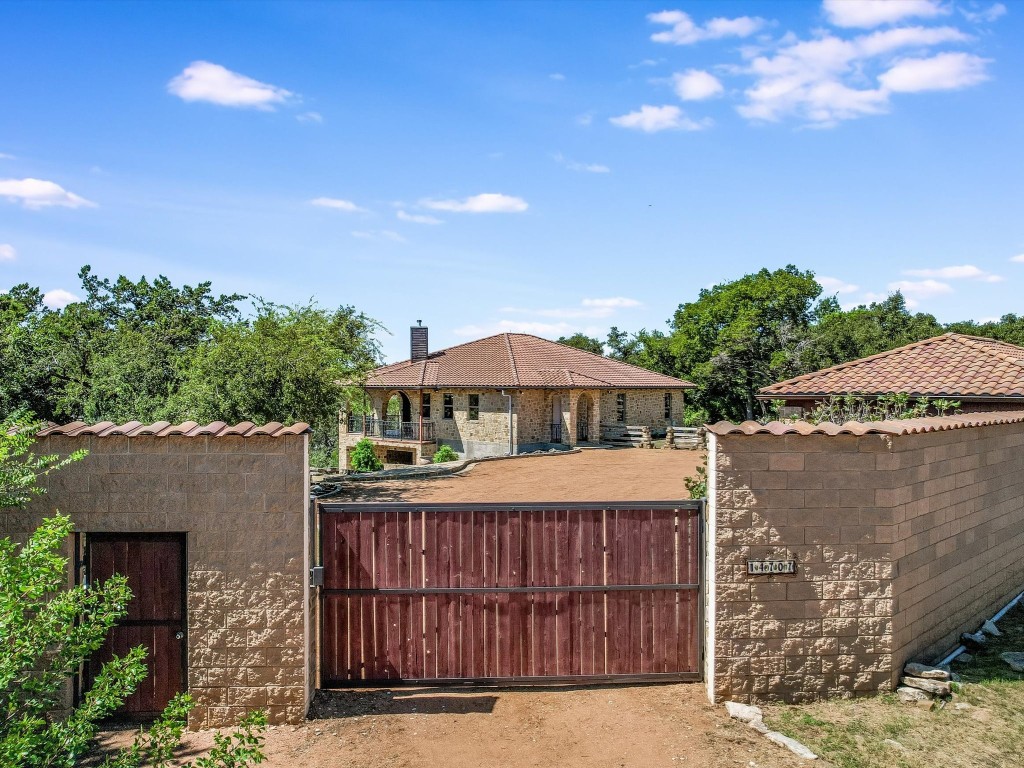 a view of a house with a patio and a yard