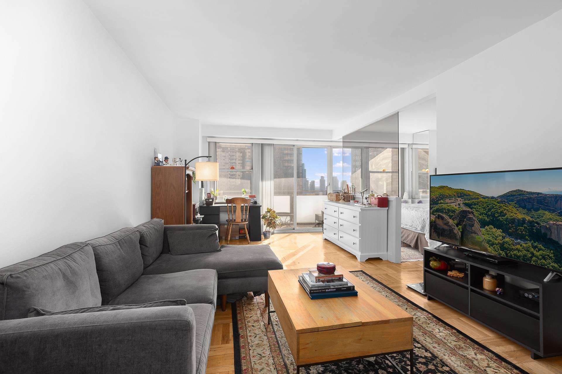 a living room with furniture and a flat screen tv