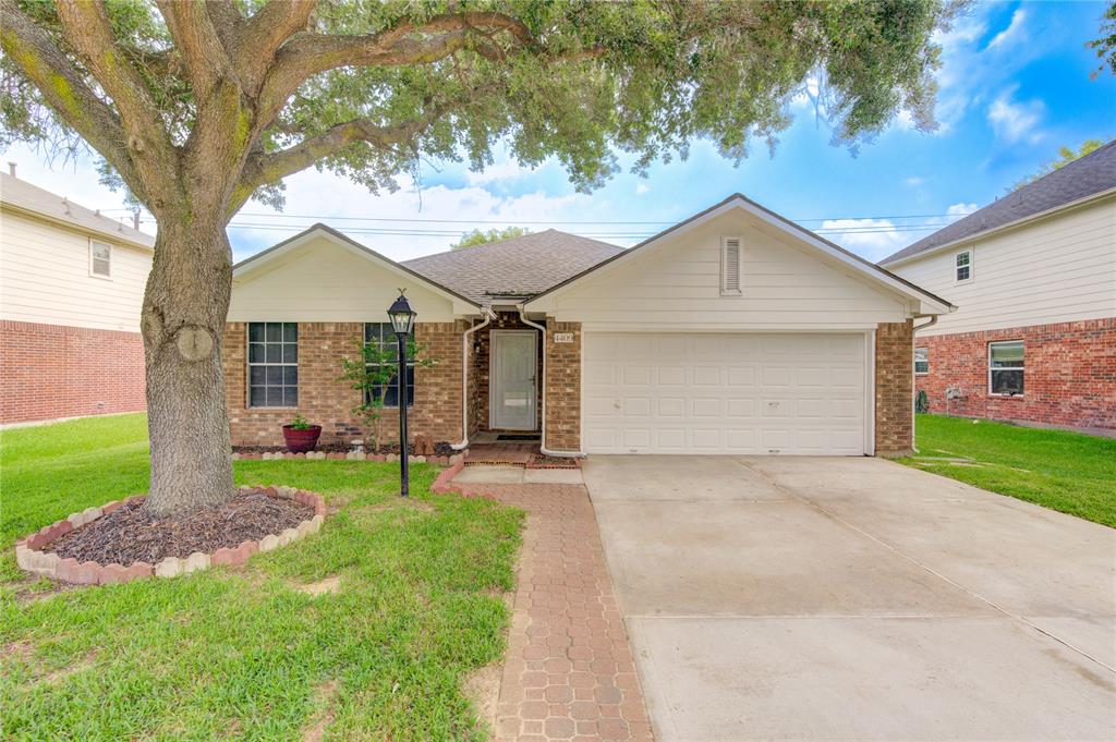 a view of a house with a yard and tree s