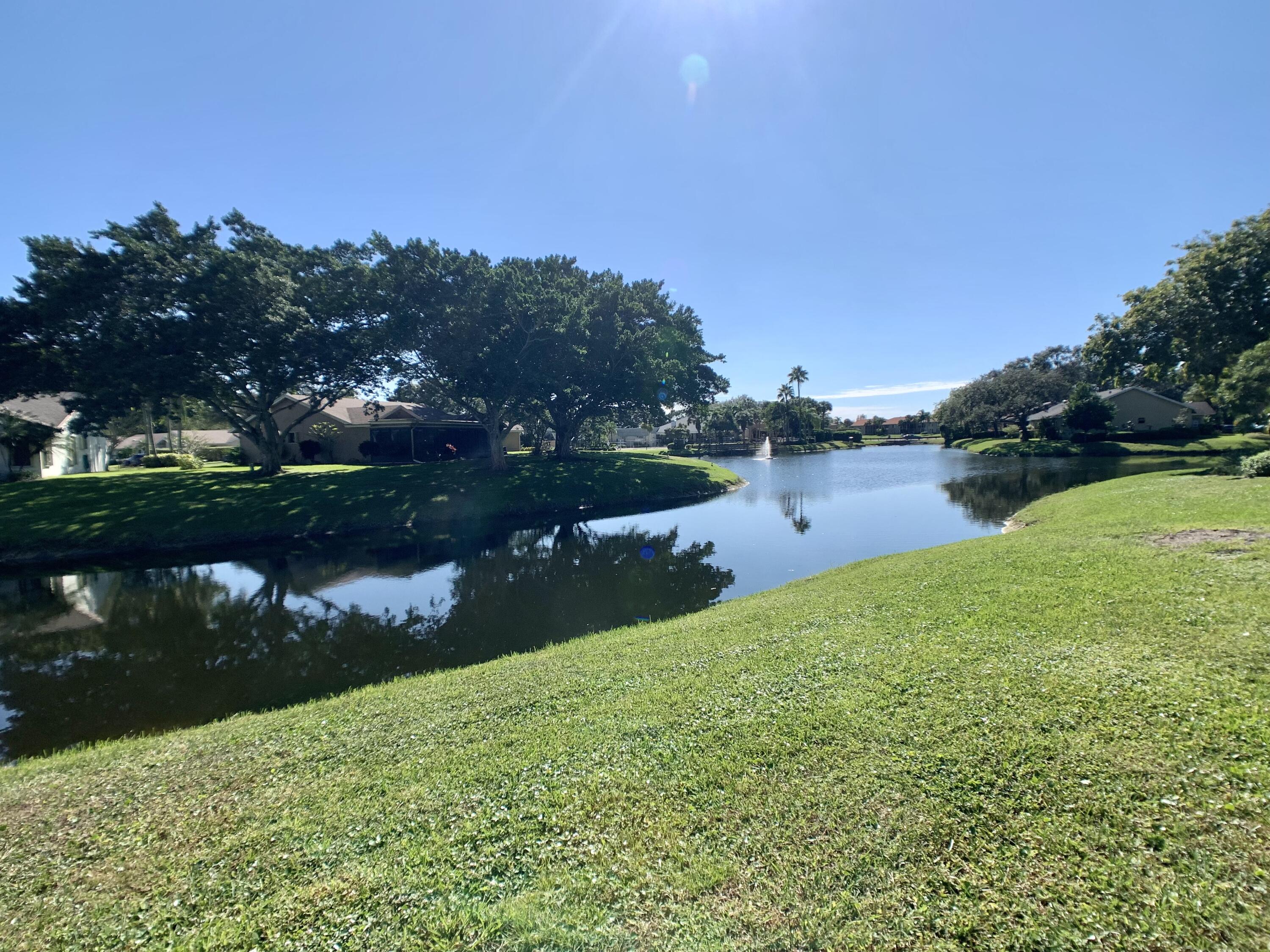 a view of a lake with houses in the back