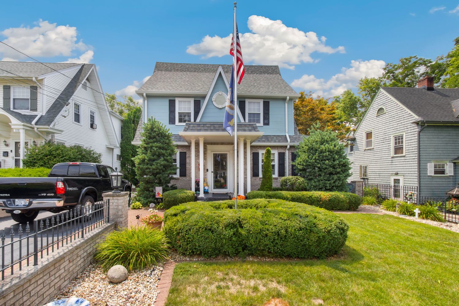 a front view of house with yard and outdoor seating