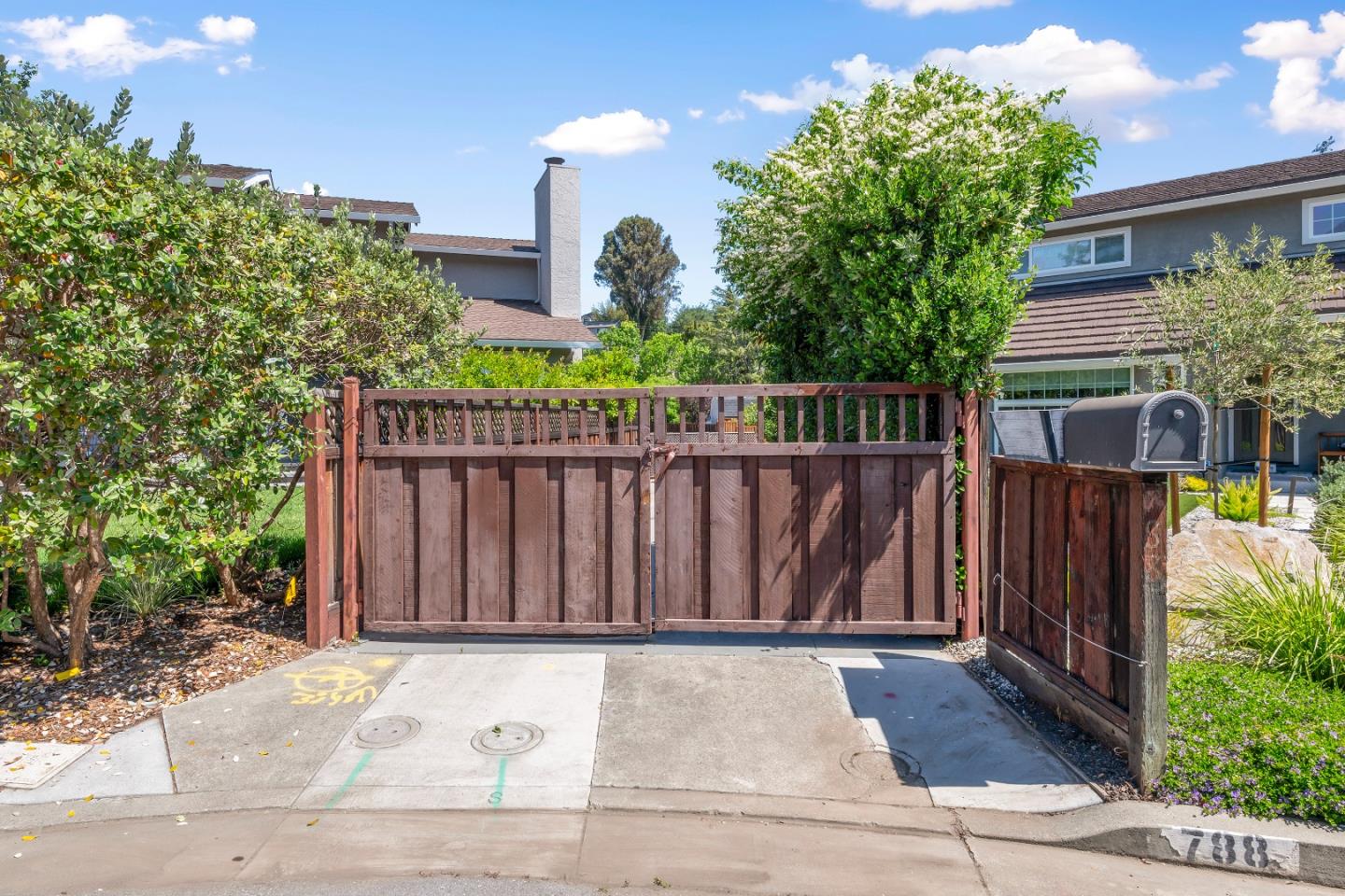 a wooden fence with potted plants in front of it