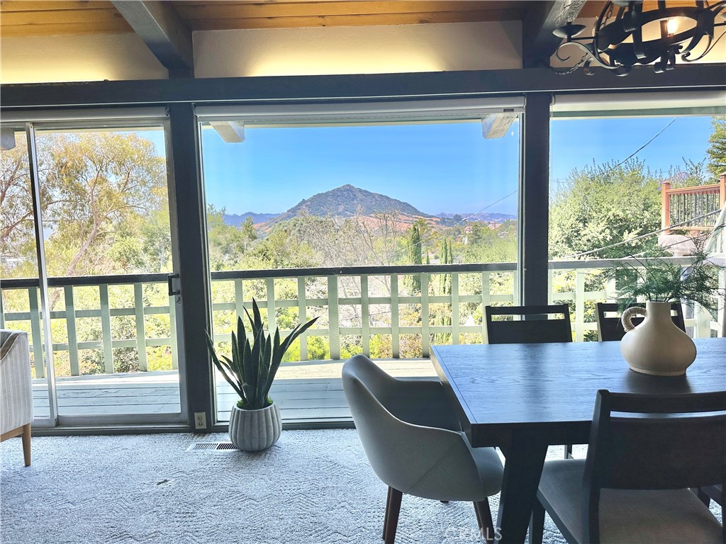 a view of a city from a dining room with large windows