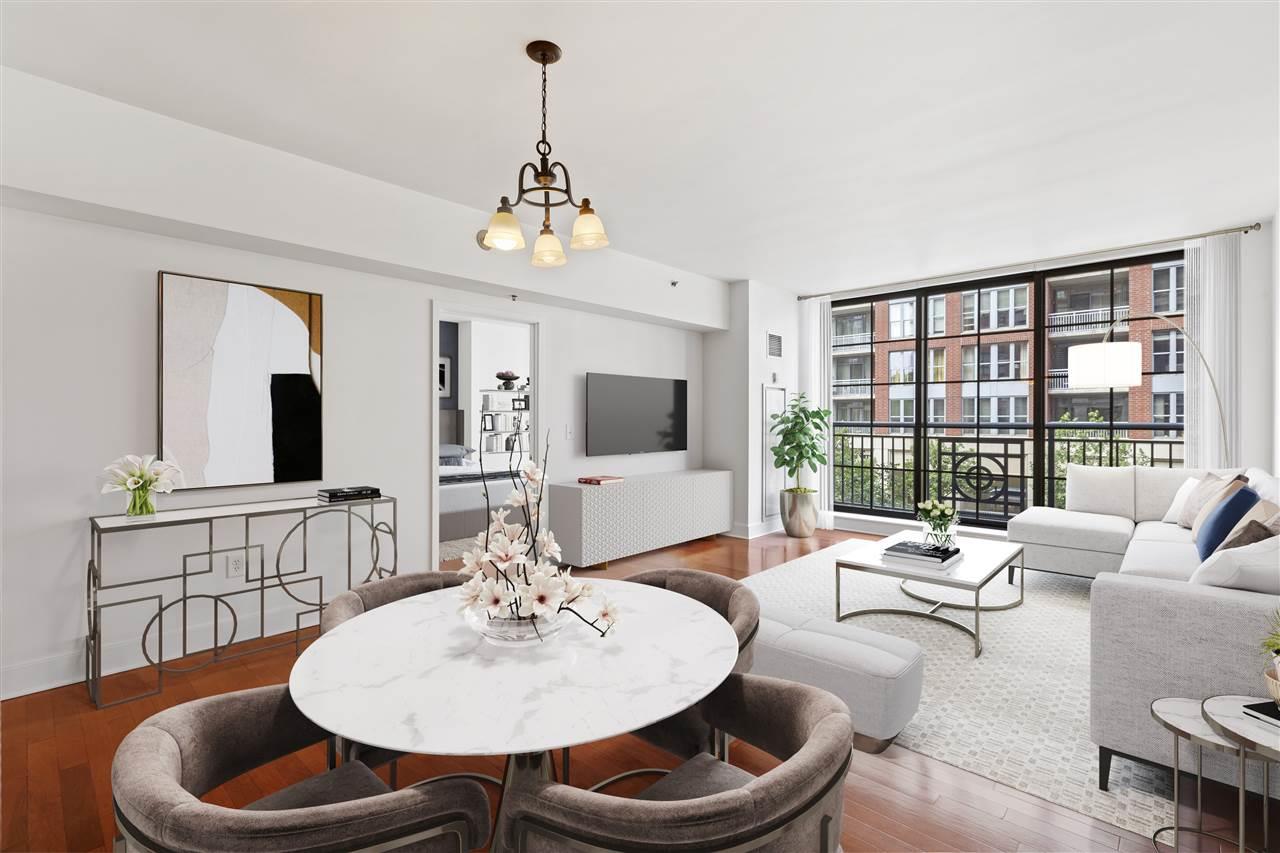 a living room with furniture a chandelier and a wooden floor