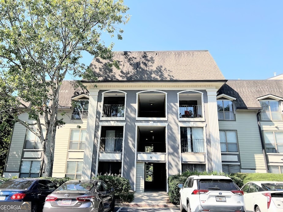 a front view of a residential apartment building with a yard