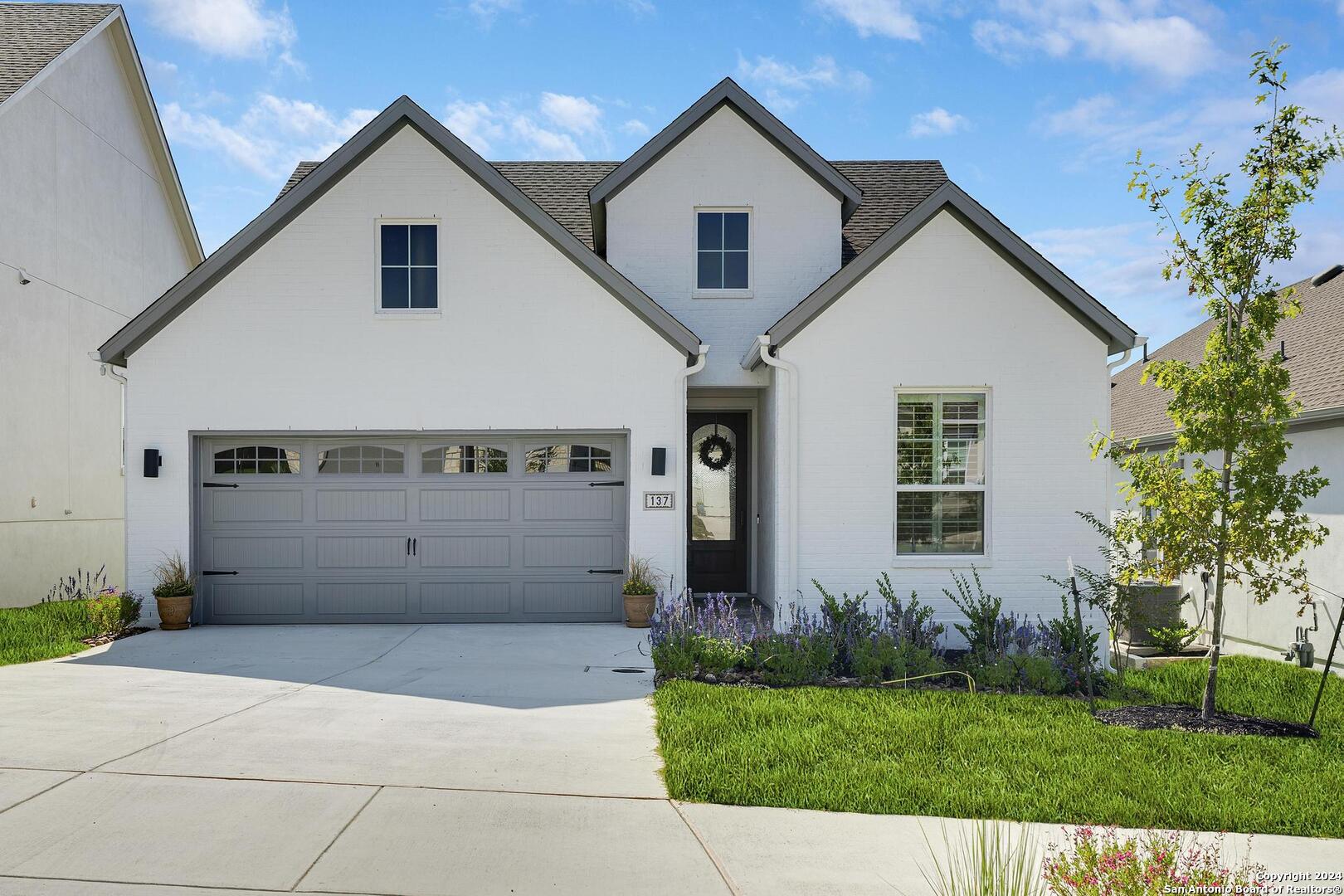 a view of a house with a yard and garage