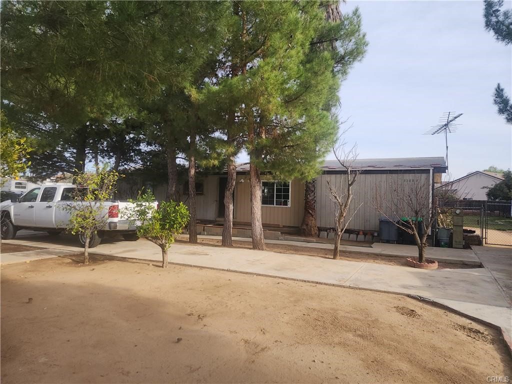 a view of a street with a building and a tree