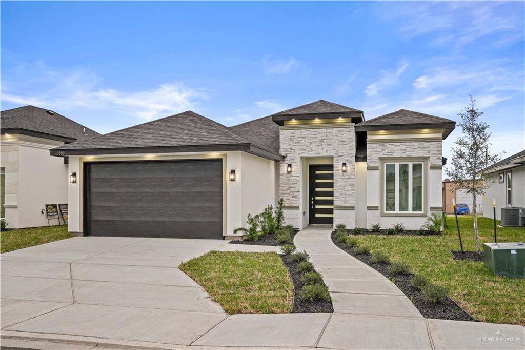 a front view of a house with a yard and garage