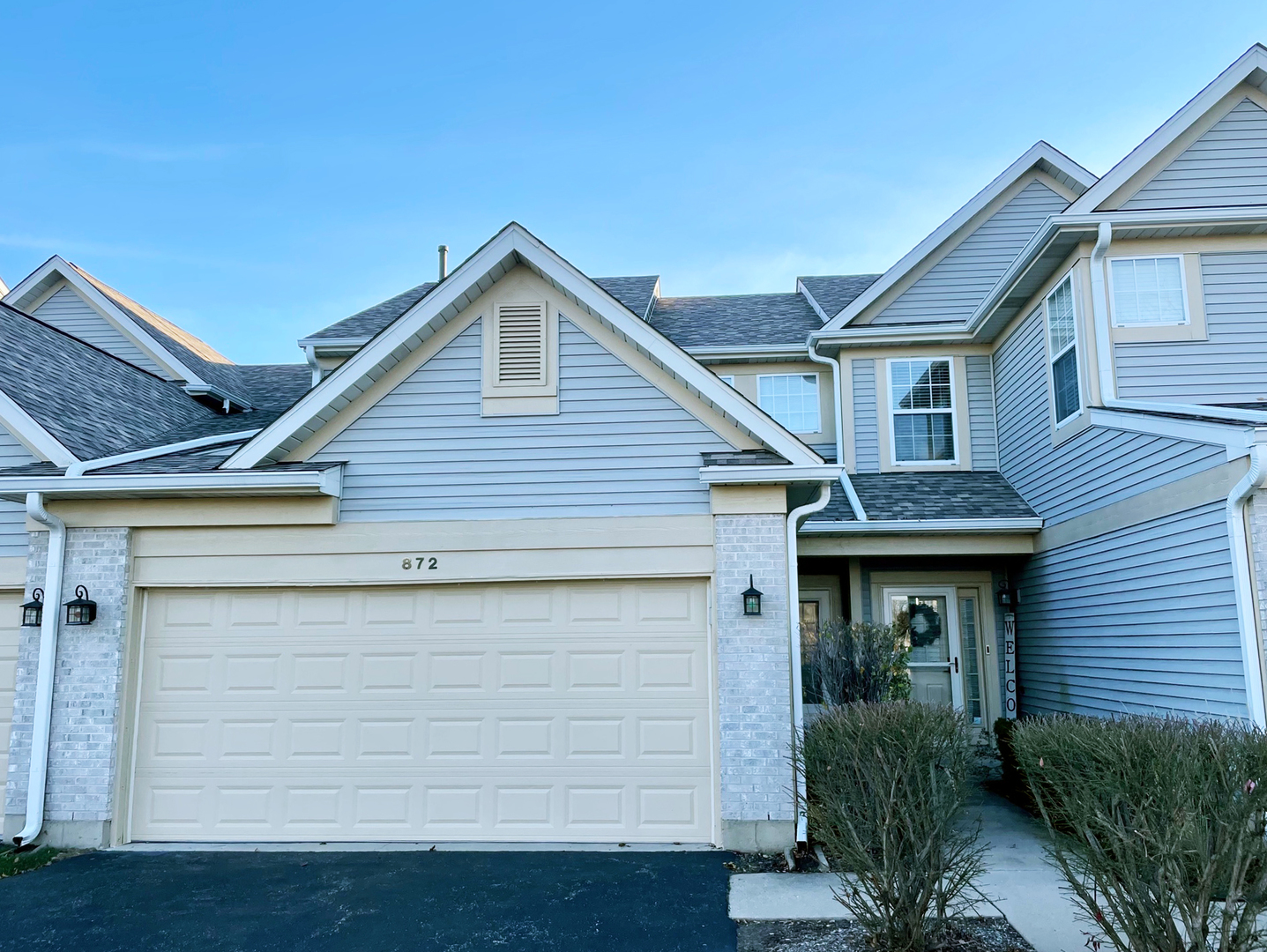 a front view of a house with garage