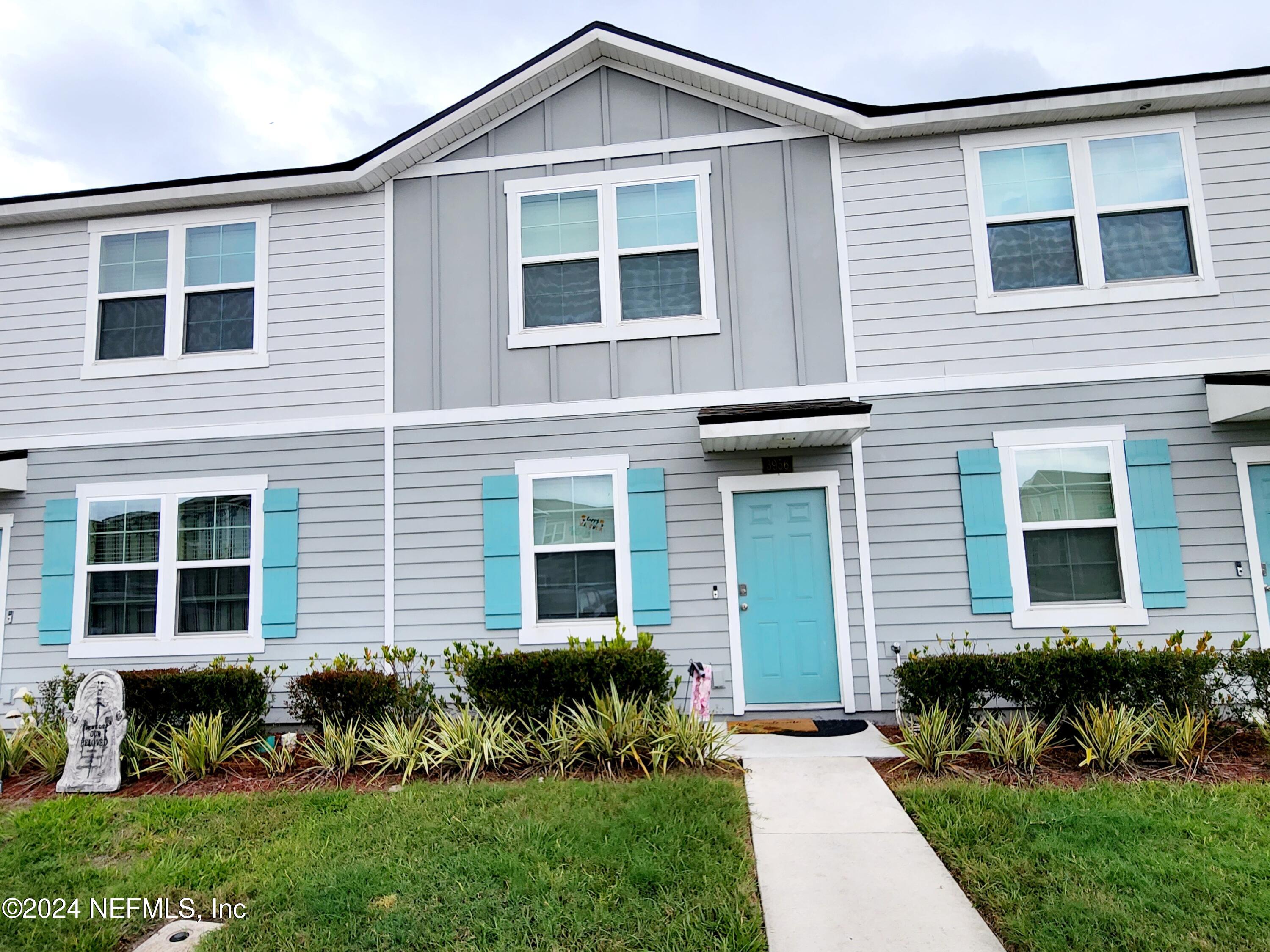 a front view of a house with a yard and outdoor seating