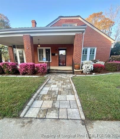 a front view of a house with a garden