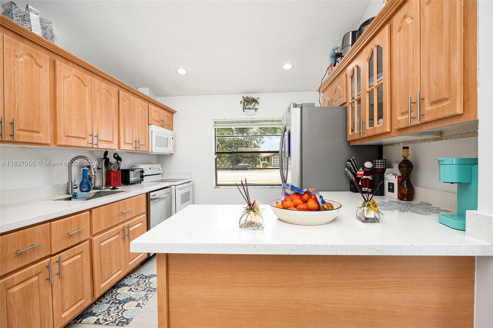 a kitchen with stainless steel appliances granite countertop a sink dishwasher and cabinets with wooden floor