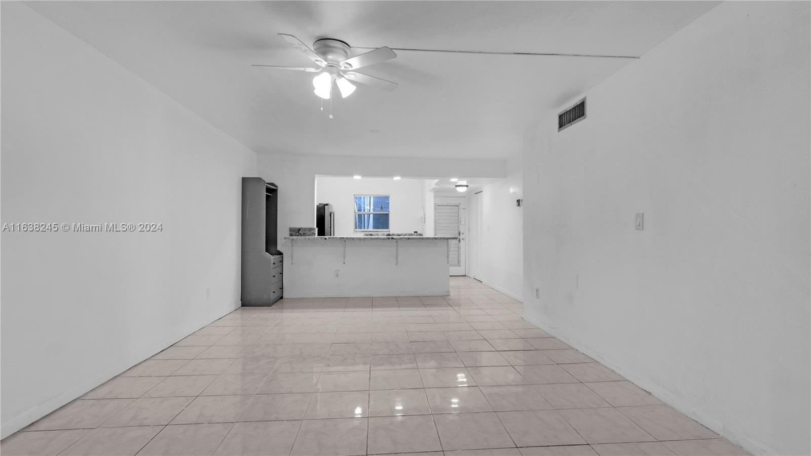 a view of a kitchen with a sink and a chandelier fan