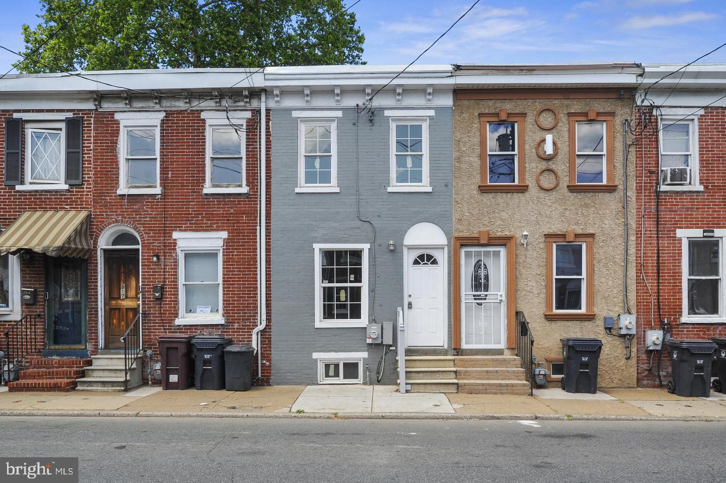 front view of a brick house with a street