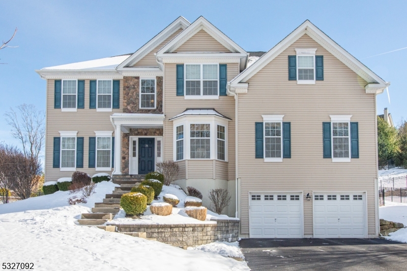 a front view of a house with a yard outdoor seating and garage