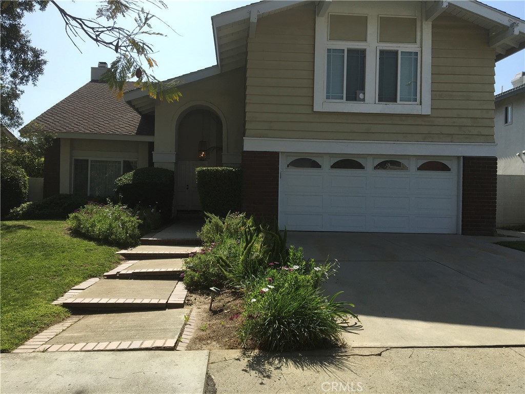 a front view of house and yard with green space